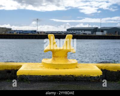 Yellow maritime bollard on the harbor Stock Photo