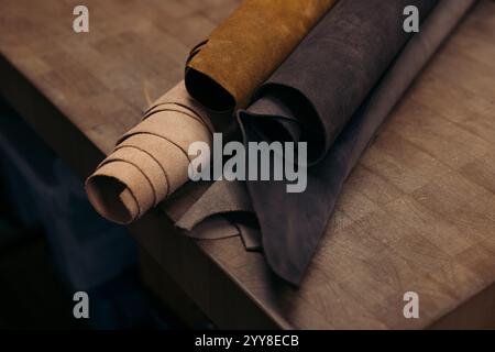 Assorted rolled leather hides in natural and earthy tones Stock Photo