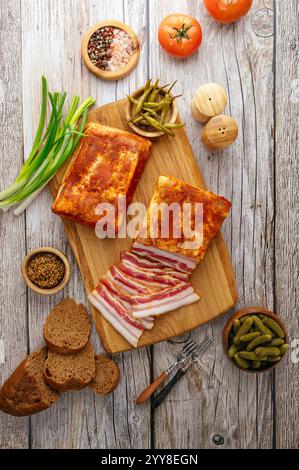 smoked lard on a board with onions and bread Stock Photo