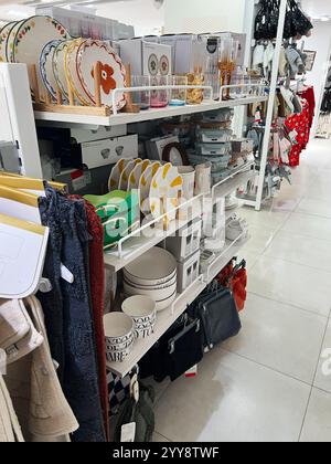 Kyiv, Ukraine - December 18, 2024: Neatly organized home goods such as plates, bowls, and textiles in a store aisle. Stock Photo