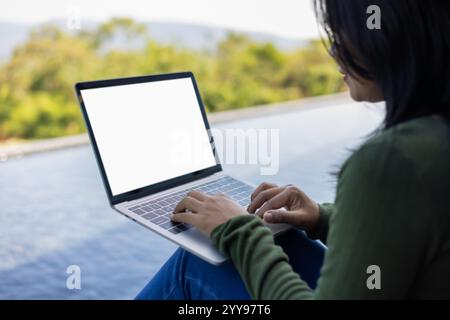 Woman use laptop and looking at it, Blank screen tablet with white background for advertising text, Woman using laptop contact business search informa Stock Photo