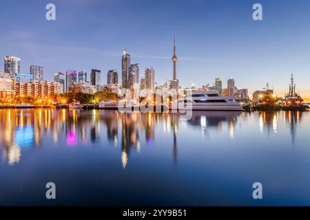 Toronto, Canada's beautiful skyline reflected in the calm harbor waters at dawn. Stock Photo