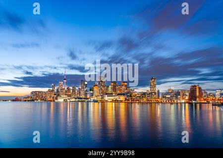 Toronto, Canada iconic skyline and towers at twilight on Lake Ontario. Stock Photo