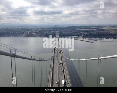 View from top of Forth Road Bridge of South Queensferry and deck with vehicles and traffic below, Scotland, UK Stock Photo