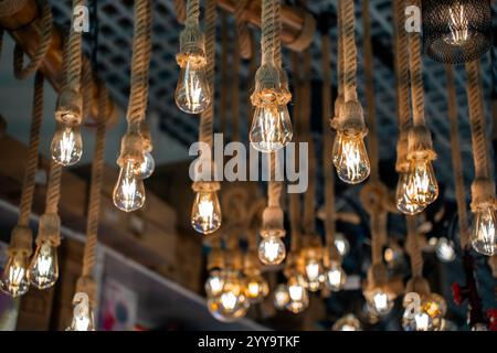 Cozy modern lights for sale! Warm glow, vintage bulbs, hanging LEDs, fairy vibes, dreamy showroom shots, perfect for decor, interiors, ambiance, light Stock Photo