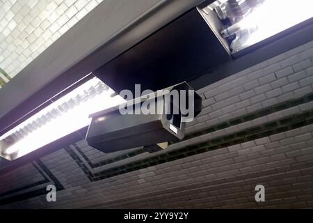 Close-up on a CCTV camera operating in the Paris Metro. Stock Photo