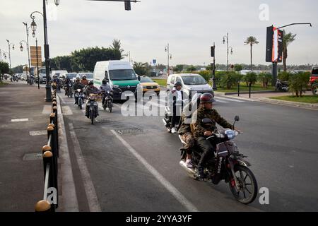 people on mopeds and small motorcycles in busy traffic downtown marrakesh, morocco Stock Photo