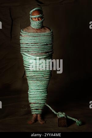 A man totally bound up with a thick rope Stock Photo - Alamy