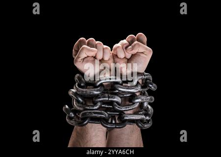 Two hands in chains isolated on black background with clipping path Stock Photo