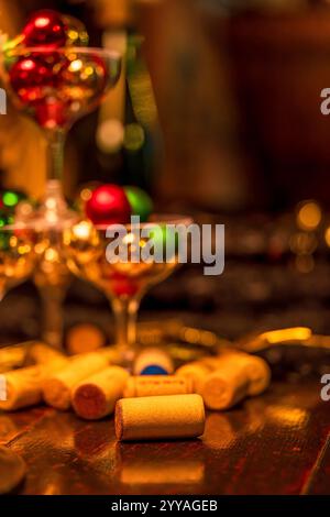 Festive Holiday Drinks Scene with Corks, Champagne Glasses, and Festive Ornaments (Warm Colours) Stock Photo