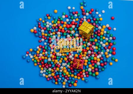 Vibrant holiday scene featuring colorful glitter balls, gift boxes, and a Merry Christmas sign. Perfect for festive occasions and celebrations. Stock Photo