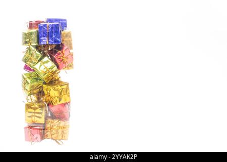 A stack of colorful shiny gift boxes arranged on a clean white background. Perfect for festive celebrations, holiday themes, and birthdays or Christma Stock Photo