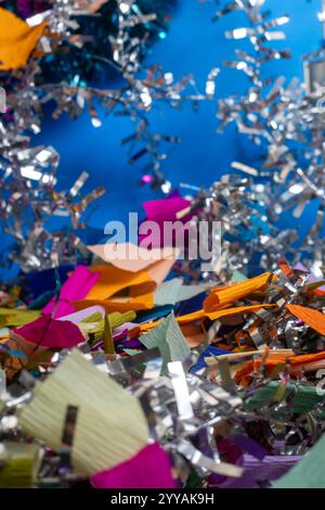 A festive and vibrant background featuring colorful confetti and shiny tinsel, perfect for celebratory events. party invitations, holiday promotions, Stock Photo