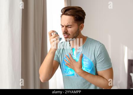 Young man using asthma inhaler at home. Illustration of lungs Stock Photo
