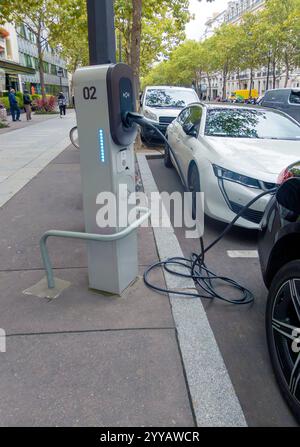 Electric vehicle charging station on pavement Paris, France Stock Photo