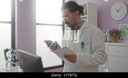 Pharmacist reviewing medication and prescription in a pharmacy setting, featuring a young hispanic man with a moustache in a white lab coat, holding a Stock Photo