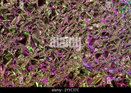 Shiny aluminun foil sheet in an abstract setting with hints of pink lighting reflecting Stock Photo