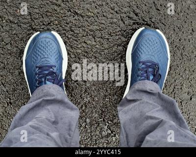 Walking shoes viewed from above on footpath Stock Photo