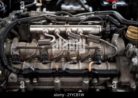 Detailed view of fuel injectors and engine components, showcasing the complexity of a modern car engine Stock Photo