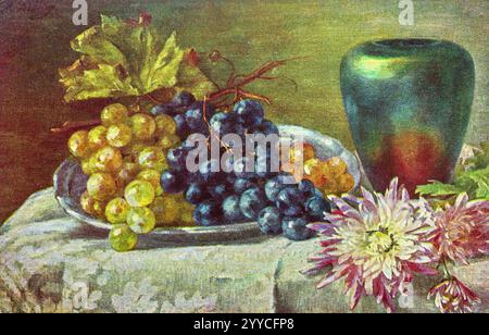 Vintage 1910-1920 postcard with still-life painting of fruits including bunches of grapes, flowers and a vase. Stock Photo