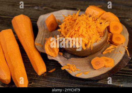 grated carrots on the table , sweet ripe orange carrots peeled, washed and grated into small pieces Stock Photo
