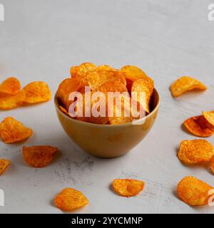 Homemade Flavored Paprika Potato Chips in a Bowl, side view. Stock Photo