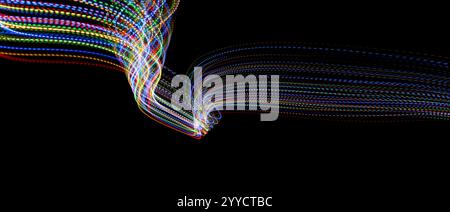 A long exposure photograph. Light painting photography with vibrant multi color lights against a black background. Stock Photo