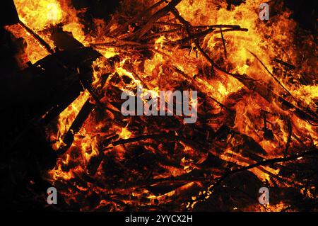 Hot fire catches pieces of wood, sparks fly around, campfire, Easter fire, Bavaria Stock Photo