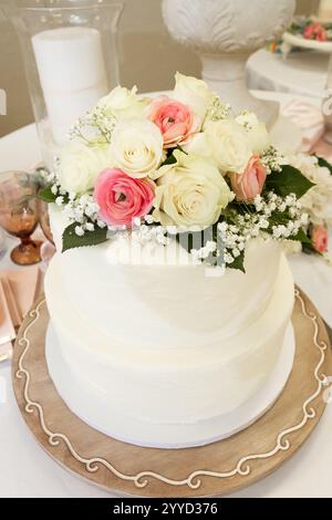 Wedding Cake with flower decorations on a table. Stock Photo