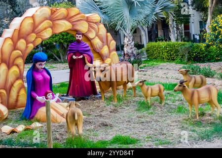 Nativity Scene Depicting Mary, Joseph, Baby Jesus, and Animals in a Manger Stock Photo