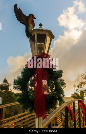 Decorative Lantern with Festive Wreath and Bow at Sunset Outdoors Stock Photo