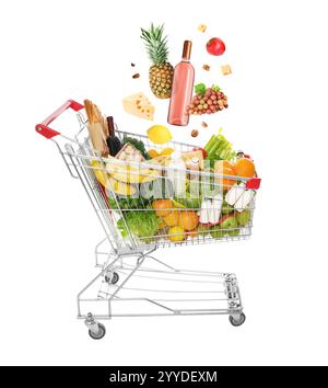 Groceries falling into shopping cart on white background Stock Photo