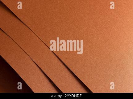 Copper and rust paper texture with a grainy, metallic finish in warm tones of orange, brown, and terracotta. The layered, overlapping design creates a Stock Photo