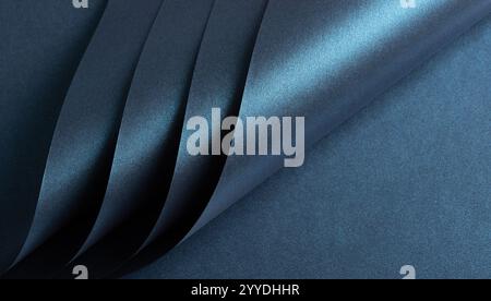 Dark blue paper texture featuring deep midnight metallic deep ocean. The grainy finish, combined with a glossy sheen, sleek gradient, and shimmering h Stock Photo