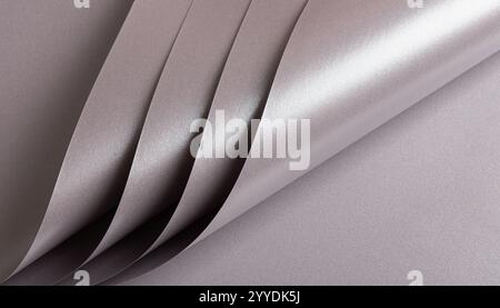 Soft gray paper texture with a metallic, glossy finish in taupe, sepia, and grayish pink with a subtle pink undertone. The shimmering gradient and sle Stock Photo