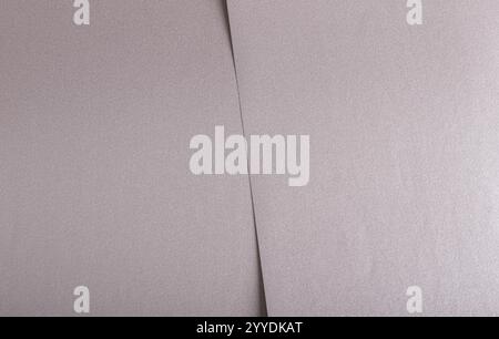 Soft gray paper texture with a satin metallic finish in taupe and sepia tones, featuring a subtle pink undertone. The muted, elegant design creates a Stock Photo