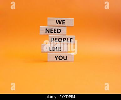 Hiring symbol. Wooden blocks with words We need People like You. Beautiful orange background. Business and Hiring concept. Copy space. Stock Photo