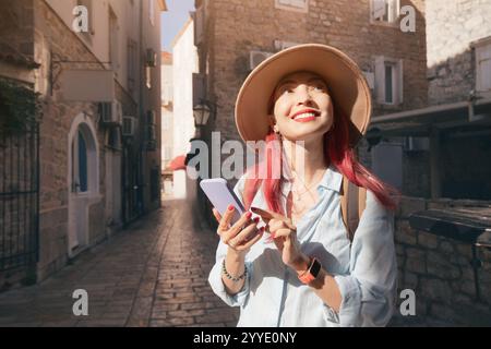 Tourist using mobile phone app for navigation while exploring budva old town, montenegro Stock Photo