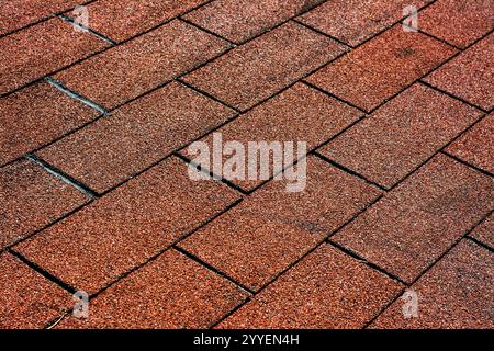 "Close-Up of Red Asphalt Shingles Roof with Uniform Pattern" Stock Photo