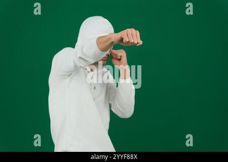 african american man in hoodie fighting on grey. High quality photo Stock Photo