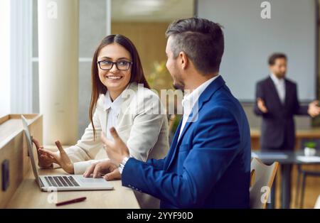 Positive Male and Female Entrepreneurs Collaborate in the Office Stock Photo