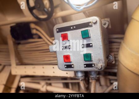 Close up of a control panel featuring red and green buttons inside a submarine, showcasing the complexity of nautical technology Stock Photo