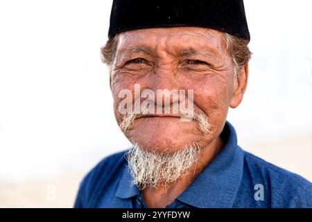 Portrait of bajau man with a traditional hat in a small village in the middle of a sea near Sulawesi, Indonesia Stock Photo