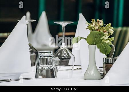 Elegantly Set Table with a White Tablecloth in a Restaurant Stock Photo
