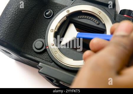 Keeping it pristine. A close-up of meticulous camera sensor cleaning. Essential maintenance for crisp, spotless images. Stock Photo