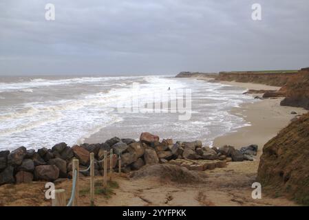 Access to beach with rough seas and eroding cliffs in winter in North Norfolk at Happisburgh, Norfolk, England, United Kingdom. Stock Photo
