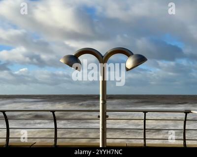 Shower heads on Blackpool promenade with motion blurred sea at high tide in background Stock Photo