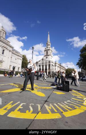 London street performer Myles Crossley, musician and busker performing in Trafalgar Square London, on a sunny day in November Stock Photo