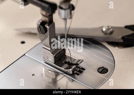 Industrial sewing machine pressure foot and sewing accessories closeup Stock Photo
