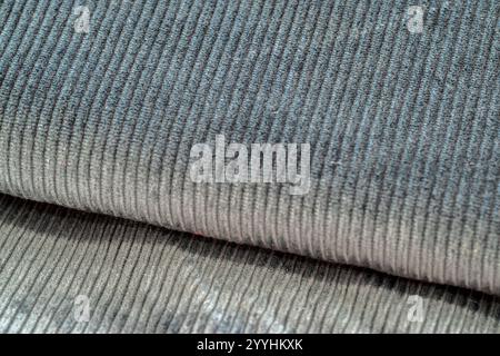 Grey textured corduroy fabric patterns closeup as textile background Stock Photo